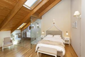 a bedroom with a large bed and a glass wall at Refugio del Roble by BeValle in Panticosa