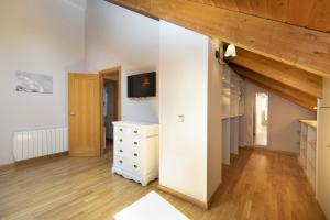 a room with a white dresser and a tv at Refugio del Roble by BeValle in Panticosa +25 photos