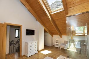 an attic bedroom with a skylight and a living room at Refugio del Roble by BeValle in Panticosa