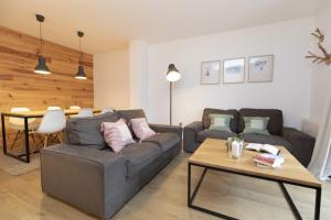 a living room with a couch and a table at Acentor Alpino by BeValle in Panticosa