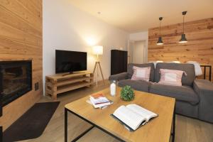 a living room with a couch and a coffee table at Acentor Alpino by BeValle in Panticosa