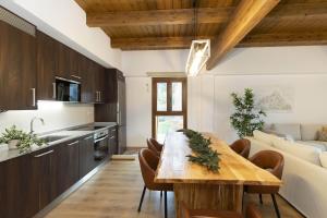 a kitchen and dining room with a wooden table at Sueños del Garmo by BeValle in Panticosa