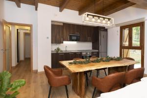 a kitchen with a wooden table and chairs at Sueños del Garmo by BeValle in Panticosa