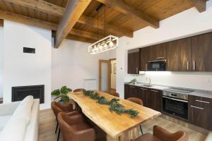 a kitchen with a wooden table and chairs at Sueños del Garmo by BeValle in Panticosa
