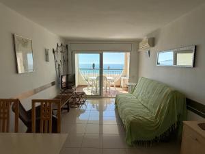 a living room with a couch and a view of the ocean at AwayDays - Apartamento en la 7a planta vista mar! in Empuriabrava