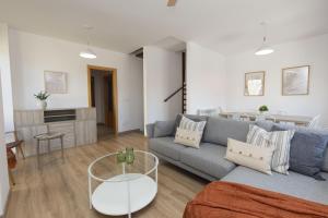 a living room with a couch and a table at Aura de Gavin by BeValle in Buesa