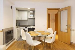 a kitchen and dining room with a table and chairs at Calma by BeValle in Panticosa