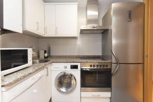 a kitchen with a stainless steel refrigerator and a dishwasher at Calma by BeValle in Panticosa