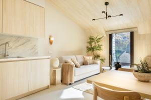 a living room with a white couch and a table at CiMa Panticosa by BeValle in Panticosa