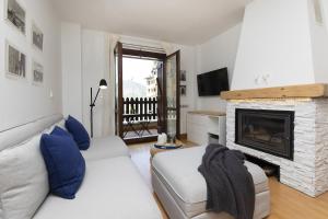 a living room with a couch and a fireplace at PanticAsa Azul by BeValle in Panticosa