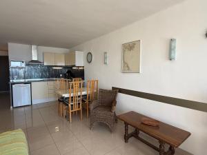 a kitchen and dining room with a table and chairs at AwayDays - Apartamento en la 7a planta vista mar! in Empuriabrava +8 photos