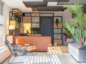a living room with chairs and a table at ibis Nice Aéroport Promenade des Anglais in Nice