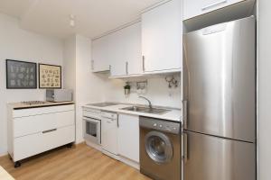 a kitchen with a stainless steel refrigerator and a dishwasher at Casa Abedul by BeValle in Panticosa