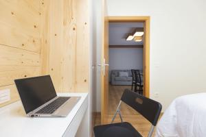 a laptop computer sitting on a desk in a room at Casa Lite by BeValle in Escarrilla
