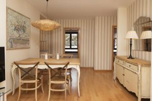 a kitchen and dining room with a table and chairs at CuMbre del Sarrio by BeValle in Panticosa +22 photos