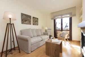 a living room with a couch and a table at CuMbre del Sarrio by BeValle in Panticosa