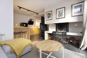 a living room with a table and a fireplace at Casa Vity by BeValle in Panticosa