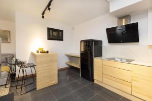 a kitchen with a black refrigerator and a sink at Casa Vity by BeValle in Panticosa