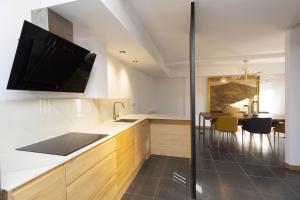 a kitchen with a sink and a tv on the wall at Casa Vity by BeValle in Panticosa