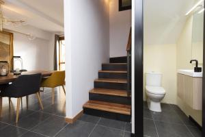 a bathroom with a toilet and a dining room with a table at Casa Vity by BeValle in Panticosa +31 photos