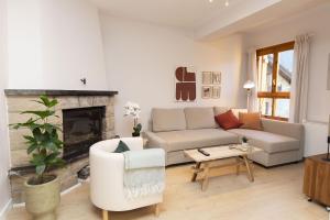 a living room with a couch and a fireplace at Casa Josephine by BeValle in Panticosa