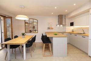 a kitchen and dining room with a table and chairs at Casa Josephine by BeValle in Panticosa