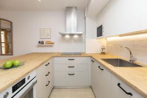 a kitchen with white cabinets and a sink at Casa Josephine by BeValle in Panticosa
