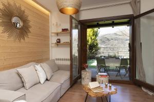a living room with a couch and a table at El Mirador by BeValle in Panticosa