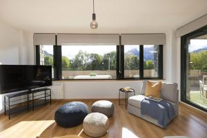 a living room with a flat screen tv and a couch at La Ventana de Saras by BeValle in Panticosa