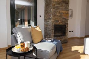 a living room with a couch and a table with food on it at La Ventana de Saras by BeValle in Panticosa