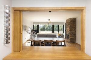 a dining room and living room with a table and chairs at La Ventana de Saras by BeValle in Panticosa +29 photos