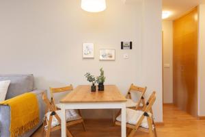 a table and chairs in a living room with a couch at Senda by BeValle in Panticosa +13 photos