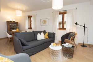 a living room with a couch and a table at Rincón del Pueyo by BeValle in El Pueyo de Jaca
