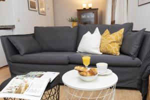 a living room with a couch and a table with a bowl of bread at Rincón del Pueyo by BeValle in El Pueyo de Jaca