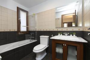 a bathroom with a toilet and a sink and a mirror at Pirenaica by BeValle in Escarrilla