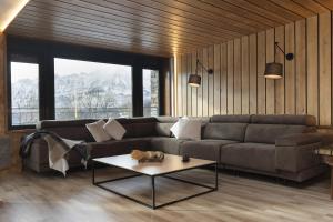 a living room with a couch and a table at Casa BellaVista by BeValle in Panticosa