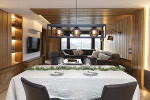 a living room with a table and a couch at Casa BellaVista by BeValle in Panticosa