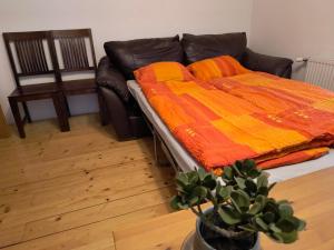 a couch with a blanket on it in a living room at Ferienwohnung Naturglück in Sellrain