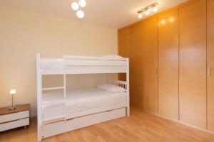 a room with two bunk beds and a closet at Altos de Argualas by BeValle in Panticosa