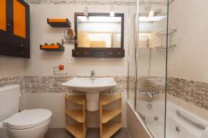 a bathroom with a sink and a toilet and a shower at Altos de Argualas by BeValle in Panticosa +20 photos