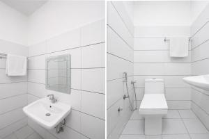 a white bathroom with a toilet and a sink at Super Hotel O Sector 45 A Chandigarh Formerly Sangam in Chandīgarh