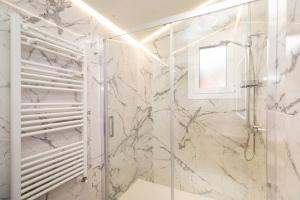 a bathroom with a shower with a glass door at Ático del Prado by BeValle in Sallent de Gállego