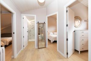 a bedroom with a bed and a mirror at Ático del Prado by BeValle in Sallent de Gállego