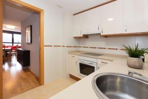 a kitchen with a sink and a stove top oven at Narnia by BeValle in Panticosa