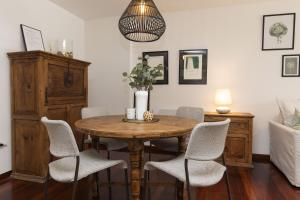 a dining room with a wooden table and chairs at Partacua by BeValle in Tramacastilla de Tena