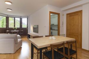 a living room with a table and a couch at Sueños de Telera by BeValle in El Pueyo de Jaca +12 photos
