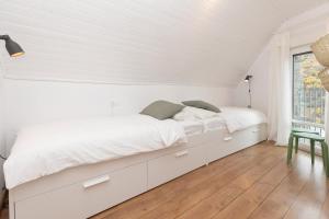 a white bedroom with a large bed and a window at Panorámica del Valle II by BeValle in Panticosa