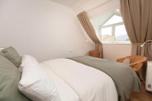 a bedroom with a white bed and a window at Panorámica del Valle II by BeValle in Panticosa +20 photos
