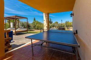 a ping pong table in the middle of a patio at Villa Son Fanals in Alcudia