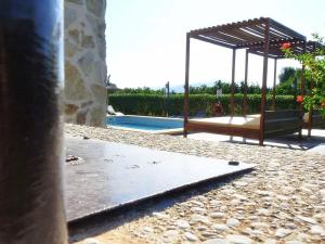 a swimming pool with a pavilion and a swing at Villa Son Fanals in Alcudia